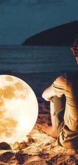 Person sitting on beach with glowing moon.