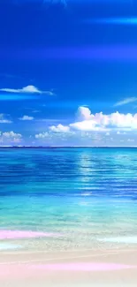 Serene beach and ocean view with blue sky and fluffy clouds.