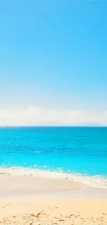 Peaceful ocean beach scene with bright blue sky and gentle waves.