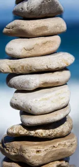 Stack of smooth stones with ocean background.