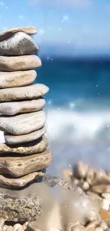 Smooth stones stacked on a serene beach with ocean view.