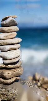 Stacked stones on a beach with blue ocean