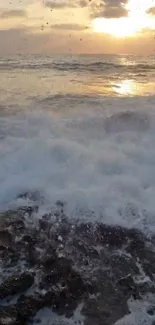 Sunrise over ocean waves with a peaceful beach view.