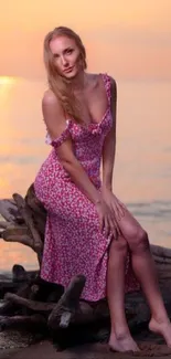 Woman in floral dress on beach at sunset.