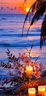 Beach sunset with candles and flowers on shore.