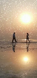 Couple walking on beach at sunset with shimmering water reflection.