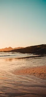 Serene sunset over a tranquil beach with golden sands and turquoise skies.