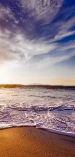 Tranquil beach at sunset with scenic ocean waves and vibrant sky hues.