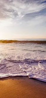 Sunset beach wallpaper with waves and orange sky.