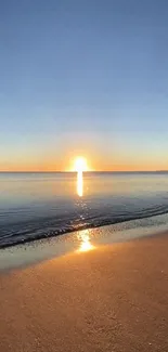 Serene sunset over a calm ocean with a golden horizon.