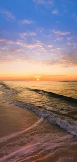 Serene beach sunset with waves under a colorful sky.