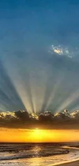 Serene beach sunset with sun rays over ocean waves.