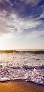 Beach sunset with waves and vibrant sky, perfect for mobile wallpaper.