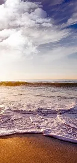 Scenic beach at sunset with waves crashing on shore under a vibrant sky.