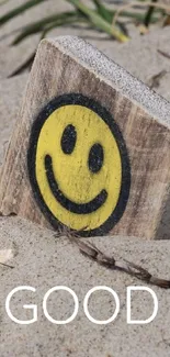 Beach wallpaper with sun and smiley design in sand.