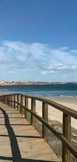 Beach walkway with ocean and blue sky.