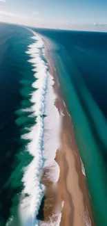 Aerial view of waves gently crashing onto a sandy beach with a serene blue ocean.