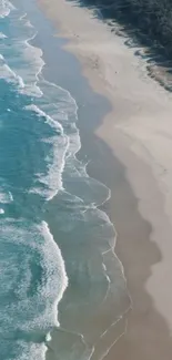 Aerial view of serene beach waves and sandy shore.