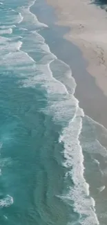 Aerial view of turquoise beach waves on a sandy coast.