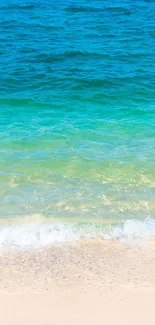 Turquoise ocean waves gently meeting a sandy beach.