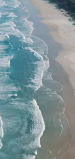 Aerial view of ocean waves softly hitting a tranquil sandy beach.