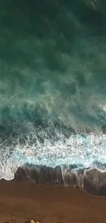 Top view of tranquil beach waves meeting the shore, showcasing serene oceanic hues.