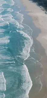 Aerial view of serene beach waves along a sandy shore, perfect for mobile wallpapers.