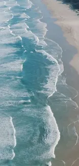 Aerial view of serene ocean waves and sandy beach.