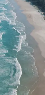 A serene beach with turquoise waves crashing onto the sandy shore.