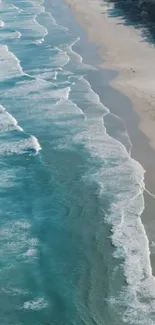 Aerial view of turquoise blue ocean waves on a sandy beach, ideal for phone wallpaper.