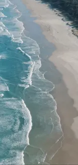 Aerial view of serene beach waves and sandy shoreline for mobile wallpaper.