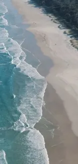 Aerial view of ocean waves on a serene beach.