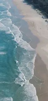 Aerial view of a serene beach with waves gently lapping the sandy shore.