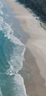 Aerial view of serene beach with blue waves.