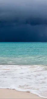 Serene beach with turquoise waters and a stormy dark sky in the background.