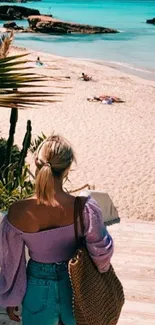 Woman at beach with clear blue water.