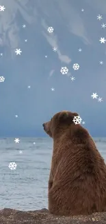 Bear on a shoreline overlooking lake and mountain.