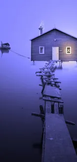 Serene blue cottage with misty dock on a tranquil lake at sunrise.