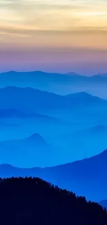 A serene blue mountain landscape at sunset, perfect for a calming wallpaper.