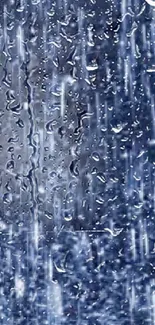 Raindrops cascading on a blue background creating a calming visual effect.