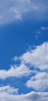 Blue sky with fluffy white clouds.