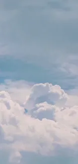 Serene blue sky with fluffy white clouds.