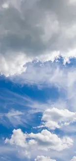 Serene blue sky with fluffy white clouds wallpaper.