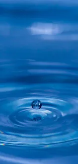 A serene blue water drop on a calm surface with ripples.