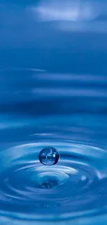 Blue water droplet creating a serene ripple effect on the surface.