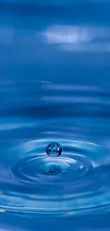 Blue water ripple with a droplet in tranquil motion.