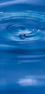 Blue water ripple with a central drop creating circular patterns.