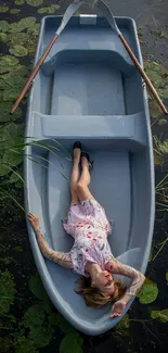 Woman relaxing in a boat on a lily-covered pond.