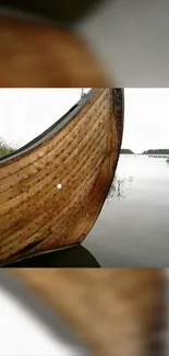 Wooden boat on calm lake with serene background.