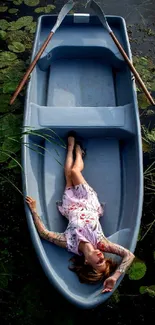 Woman relaxing in a boat on calm water surrounded by green foliage.